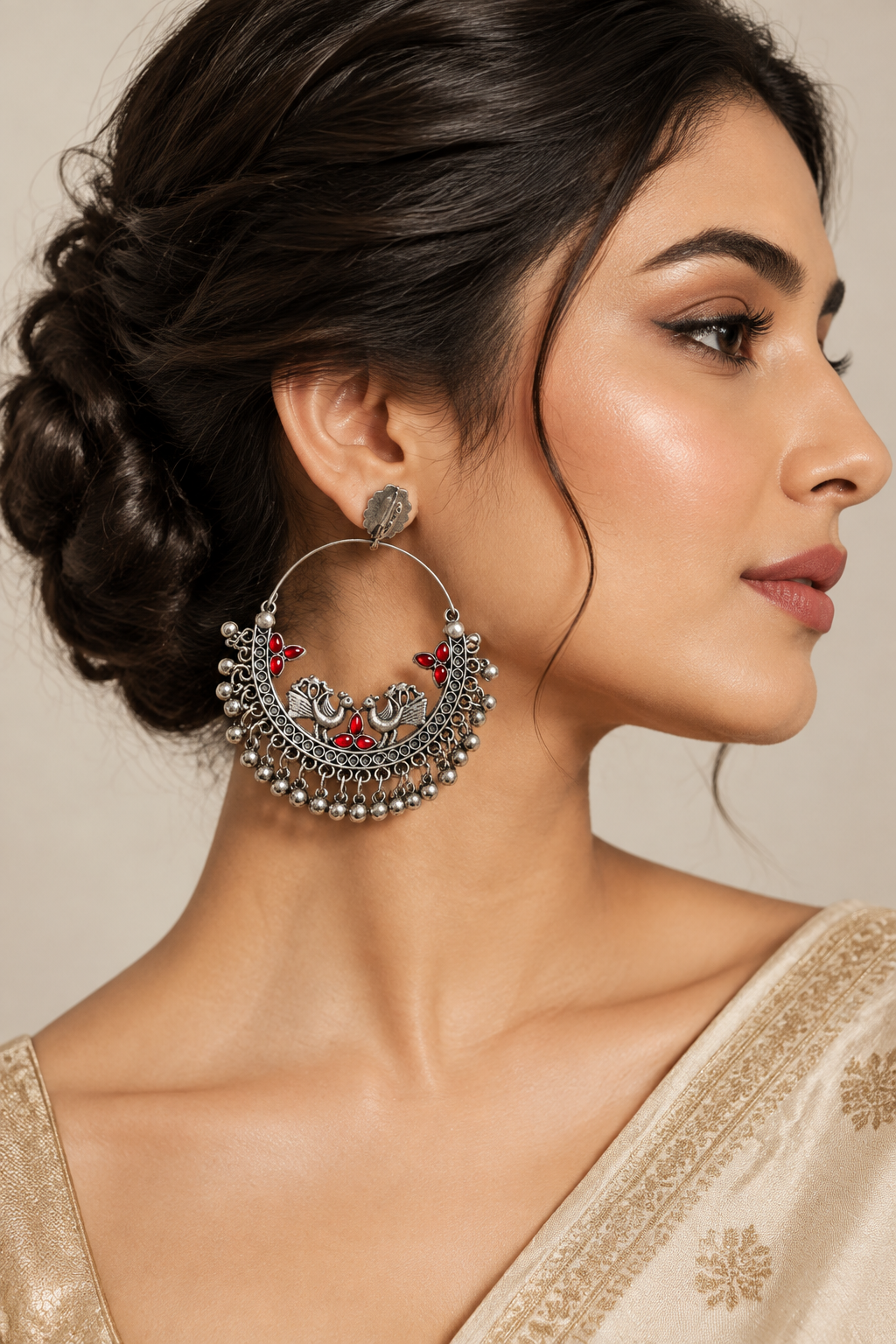 Red worn on model: Side view of a model wearing silver-tone peacock chandbali earrings with red accents and ghungroo fringe.