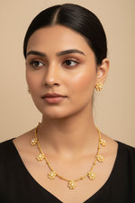 A dainty gold-toned necklace featuring five pearl floral motifs and uniquely tapered teardrop-shaped floral stud earrings.