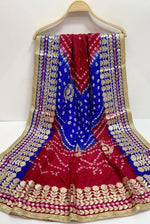 A dupatta/chunni/urrhni/scarf in fresh royal blue, hot pink colours with gota and bootis work displayed on a hanger.