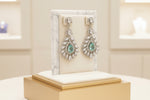  A earrings stand with leaf designs, featuring American diamonds turquoise semi-precious stones. Party wear earrings. 