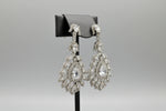  A earrings stand with leaf designs, featuring American diamonds whtie semi-precious stones. Party wear earrings. 