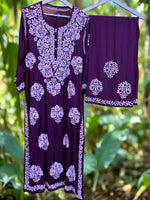 A floral embroidered purple kurta set with palazzo trousers.