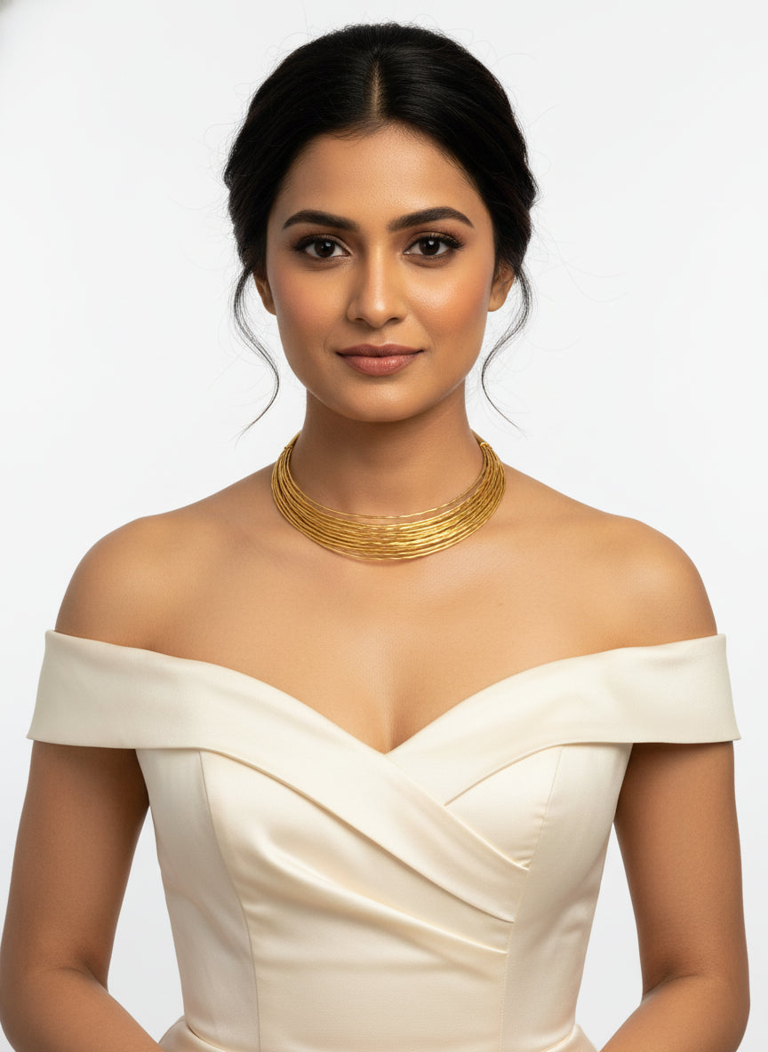 A gold plated multi layer Hasli necklace by famaza couture 