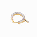 A gold-plated huggie hoop earring adorned with clear pavé-set cubic zirconia stones and a small teardrop-shaped stone dangling from the clasp, shown on a plain white background.