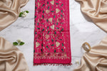 A hot pink colour pashmina scarf with Kashmiri embroidery in a floral pattern, featuring tassels on the ends.