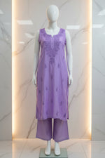 A lavender purple chanderi fabric sleeveless embroidered kurta hanging on a white hanger with matching straight trousers displayed for Famaza Couture 