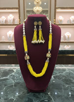 A luxurious Tanjore Art Meenakari beaded Mala Set featuring a bridal pearl necklace with accompanying earrings, predominantly in gold and white colours with ornate designs.