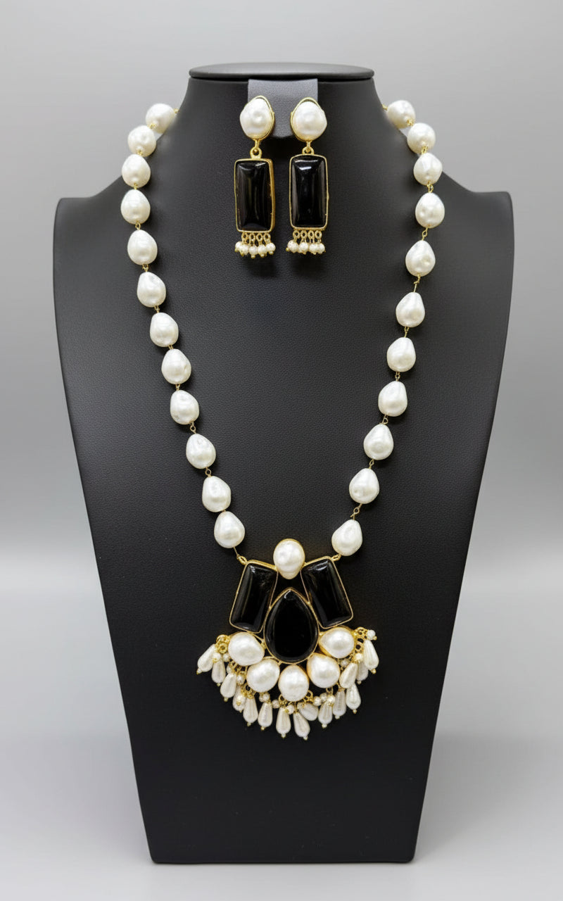 A luxury Bollywood style Mala Set featuring white beads, pearls, and black stones inclusions, displayed on a mannequin bust. Party wear set.