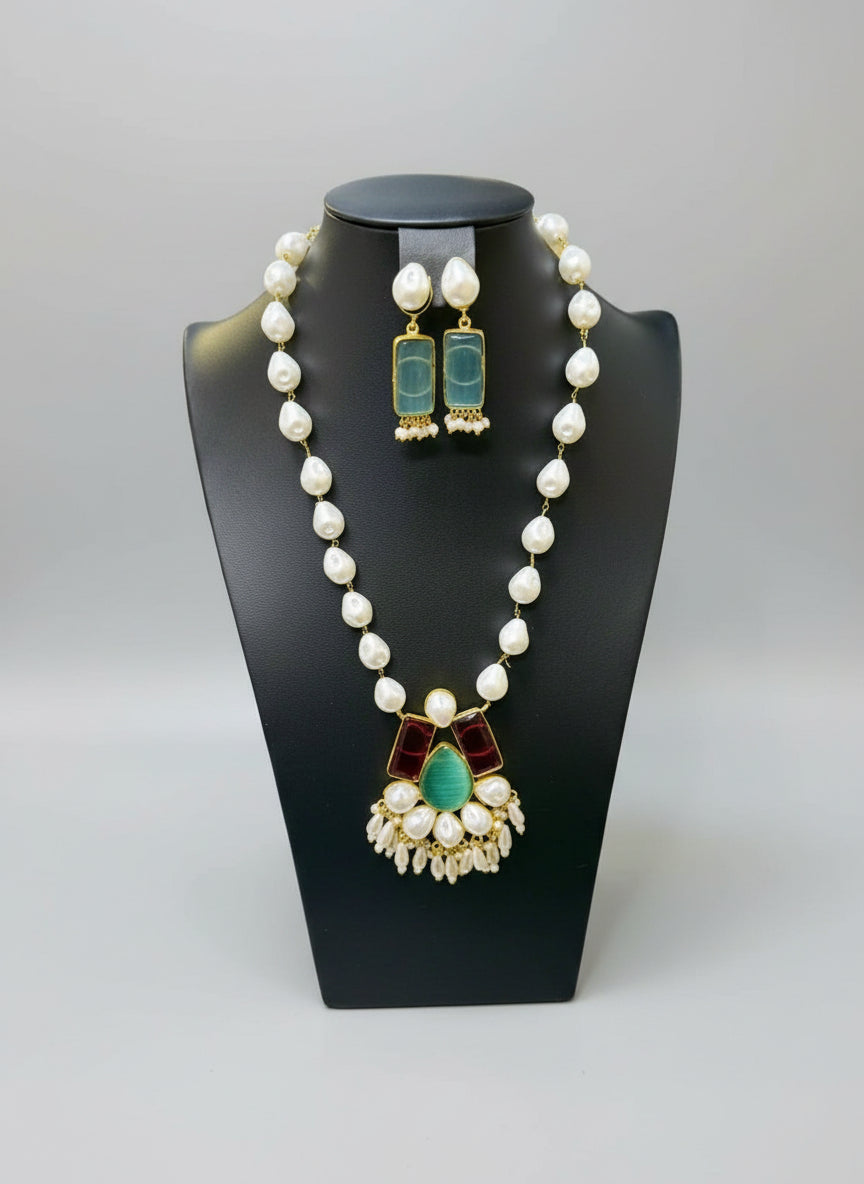 A luxury Bollywood style Mala Set featuring white beads, pearls, and ocean blue and maroon stone inclusions, displayed on a mannequin bust. Party wear set. 