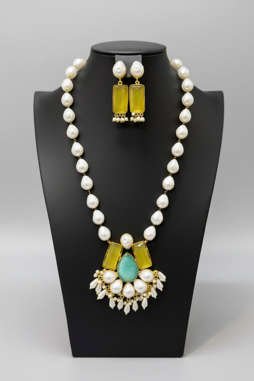 A luxury Bollywood style Mala Set featuring white beads, pearls, and yellow and turquoise stone inclusions, displayed on a mannequin bust. Party mala wear set. 