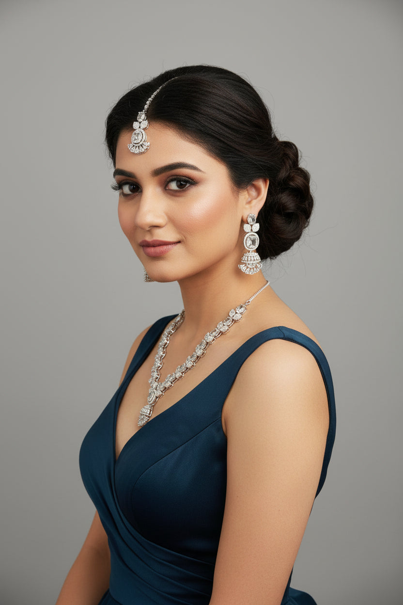 A mannequin showcasing a silver plated necklace set with white ad stones, accompanied by earrings and a maang tikka. Party wear set. 