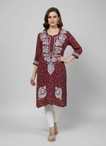 A maroon colour floral printed and hand embroidered Georgette kurti with Ghass Patti work displayed.