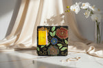 A multi-coloured floral handcrafted tote bag with glass beads embroidered on it, displayed on a wooden surface