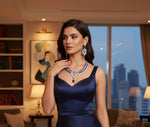 A necklace and earrings set featuring leaf elements, with blue sapphire stones and American diamonds. Party wear posh jewellery set. 