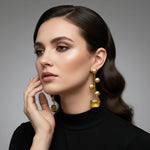 A pair of gold-plated earrings with yellow Monalisa stone and coin details.