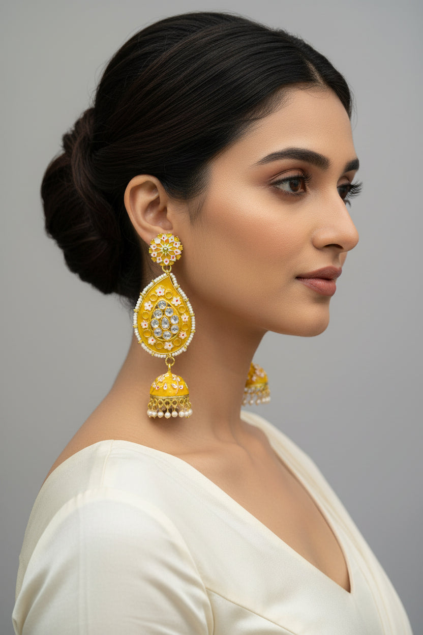 A pair of gold-plated mustard Meenakari long Jhumka earrings with mustardenamel paint and nano pearl drops, displayed on a stand.