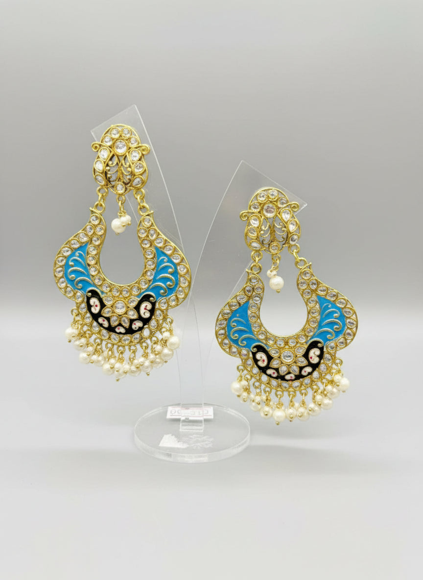 A pair of gold-toned chandbali earrings with blue and black minakari and kundan studded details along with pearls. Party wear.