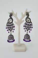 The Royal Mayura oxidised peacock figure jhumka earrings with beaded accents by Famaza Couture.