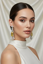 Model wearing the 6cm long drop Aurora American Diamond chandelier earrings to showcase scale and evening party wear styling