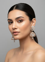 A pair of small handcrafted black polish American diamond jhumka earrings with a black and rose gold small ad stones.