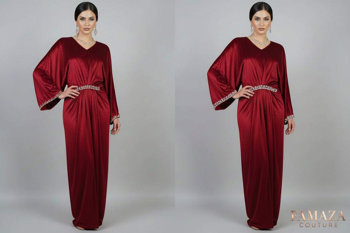 A red velvet kaftan dress displayed on a mannequin, featuring a batwing sleeve design and a V-neckline.