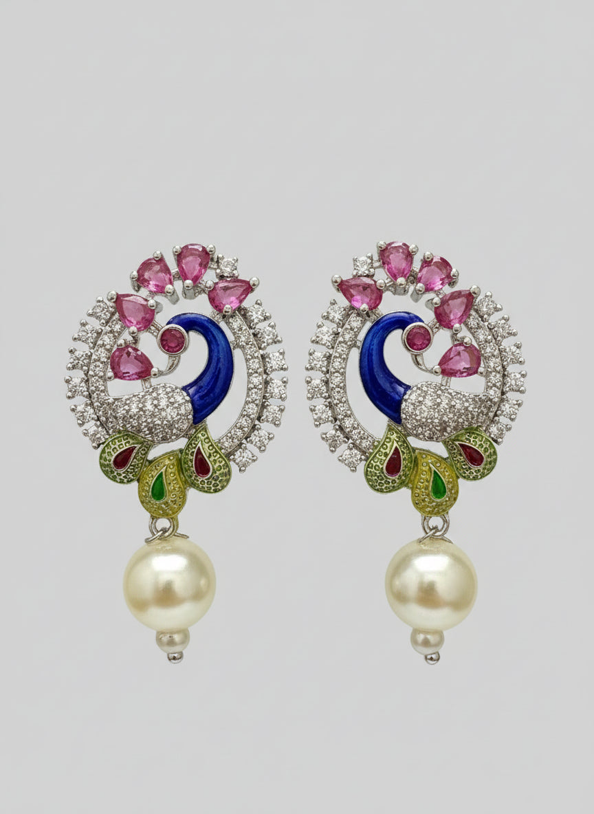 A rhodium-plated peacock design accompanied earrings, featuring vibrant green, blue, enamel accents, as well as sparkling crystal white and ruby pink stones. Earrings design is focused. 