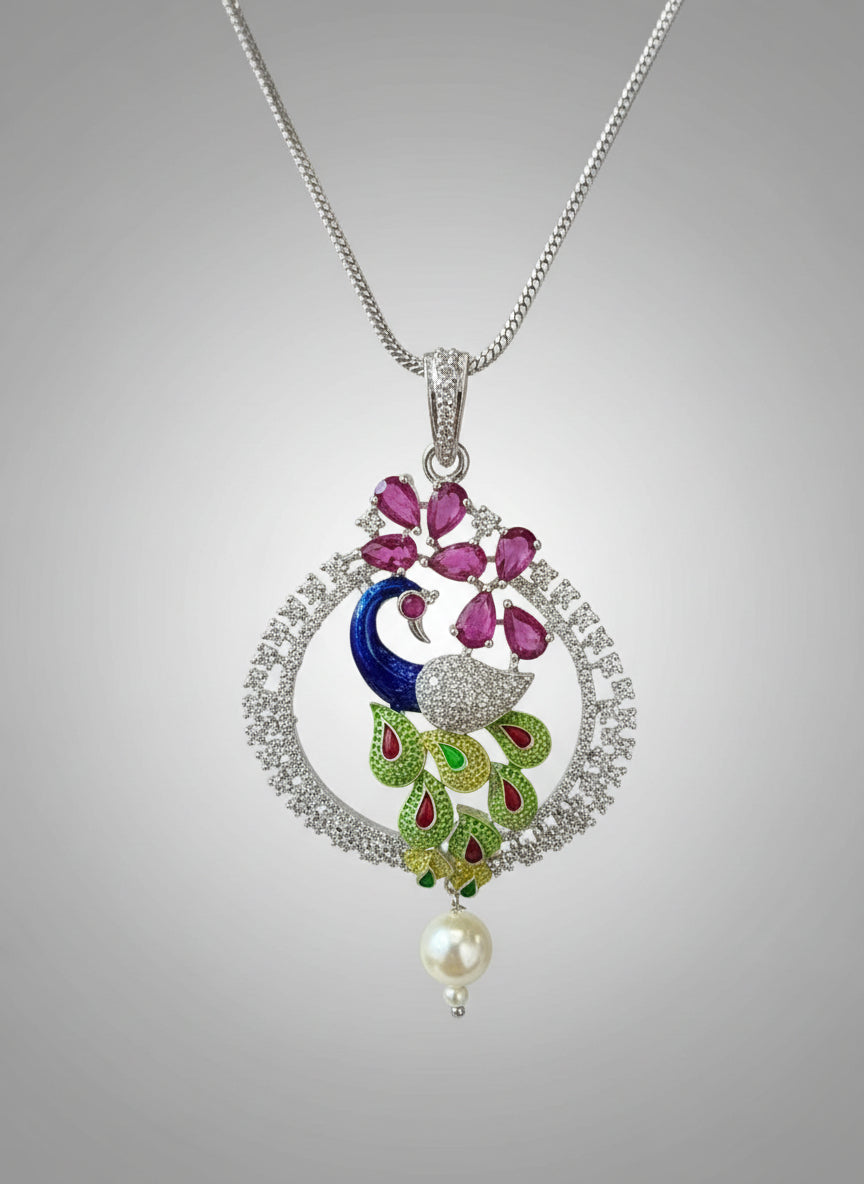 A rhodium-plated peacock design pendant with silver chain ,featuring vibrant green, blue, enamel accents, as well as sparkling crystal white and ruby pink stones. Pendant with silver chain design is focused. 