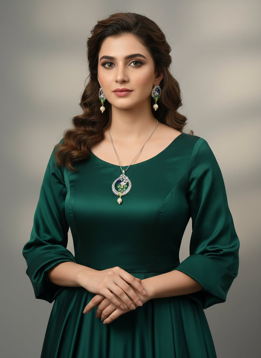 A rhodium-silver plated brass pendant with a peacock design accompanied by earrings, featuring vibrant green, blue, and gold enamel accents, as well as sparkling white AD stones embellishments. Party wear jewellery set. 
