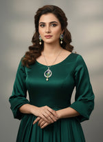 A rhodium-silver plated brass pendant with a peacock design accompanied by earrings, featuring vibrant green, blue, and gold enamel accents, as well as sparkling white AD stones embellishments. Party wear jewellery set. 