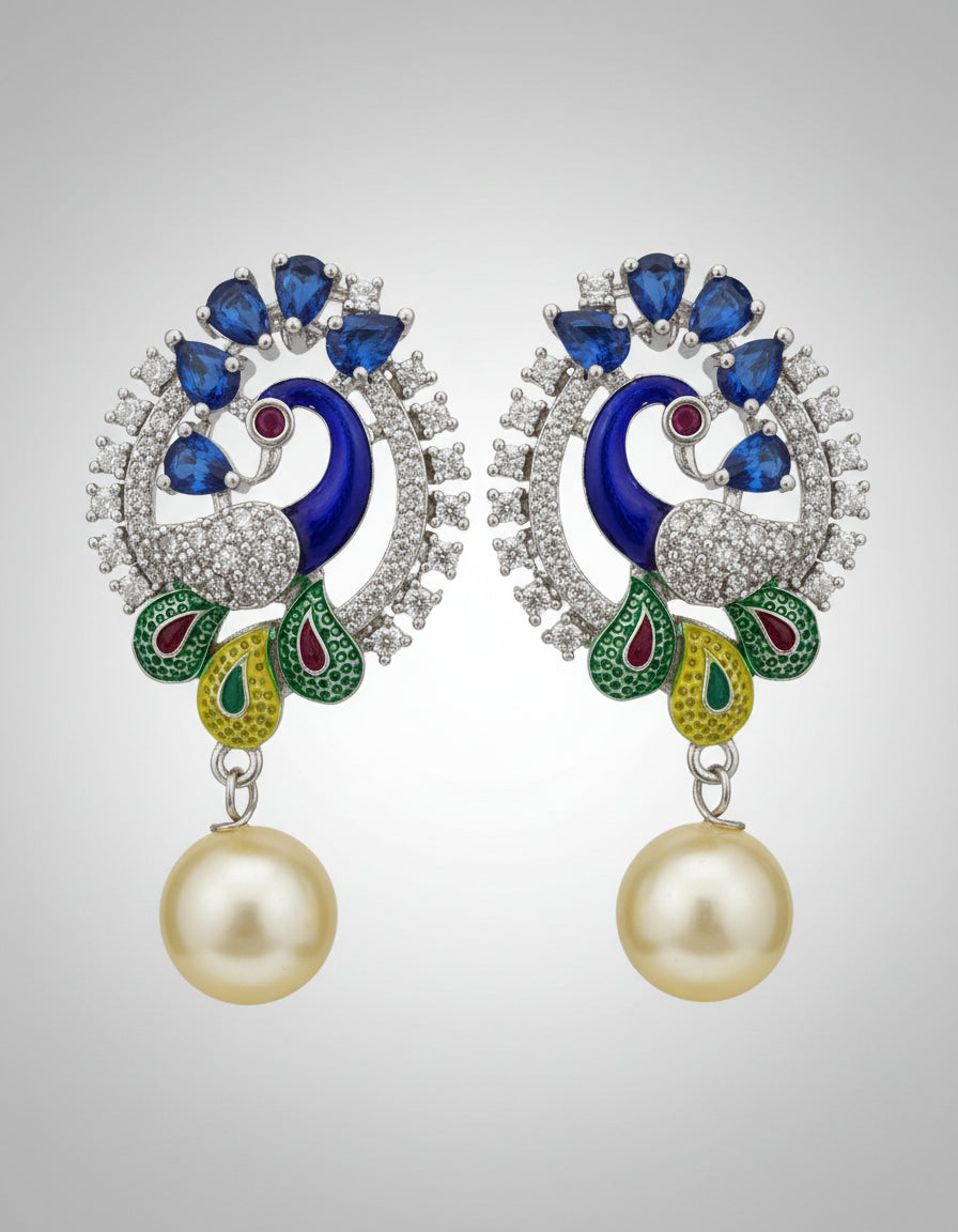 A rhodium-silver plated peacock design accompanied earrings, featuring vibrant green, blue and yellow enamel accents, as well as sparkling white and blue AD crystal stones. Earrings design is focused. Party wear earrings. 
