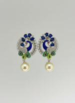 A rhodium-silver plated peacock design accompanied earrings, featuring vibrant green, blue, enamel accents, as well as sparkling crystal white and blue AD stones. Earrings design is focused. 