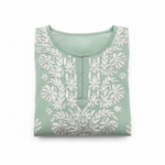 A sage green cotton tunic top with white floral and leaf embroidery, hanging on a wooden hanger against a white background.