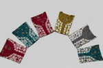 A selection of long kurta-shirts displayed in various colours, each featuring intricate floral embroidery across the front.