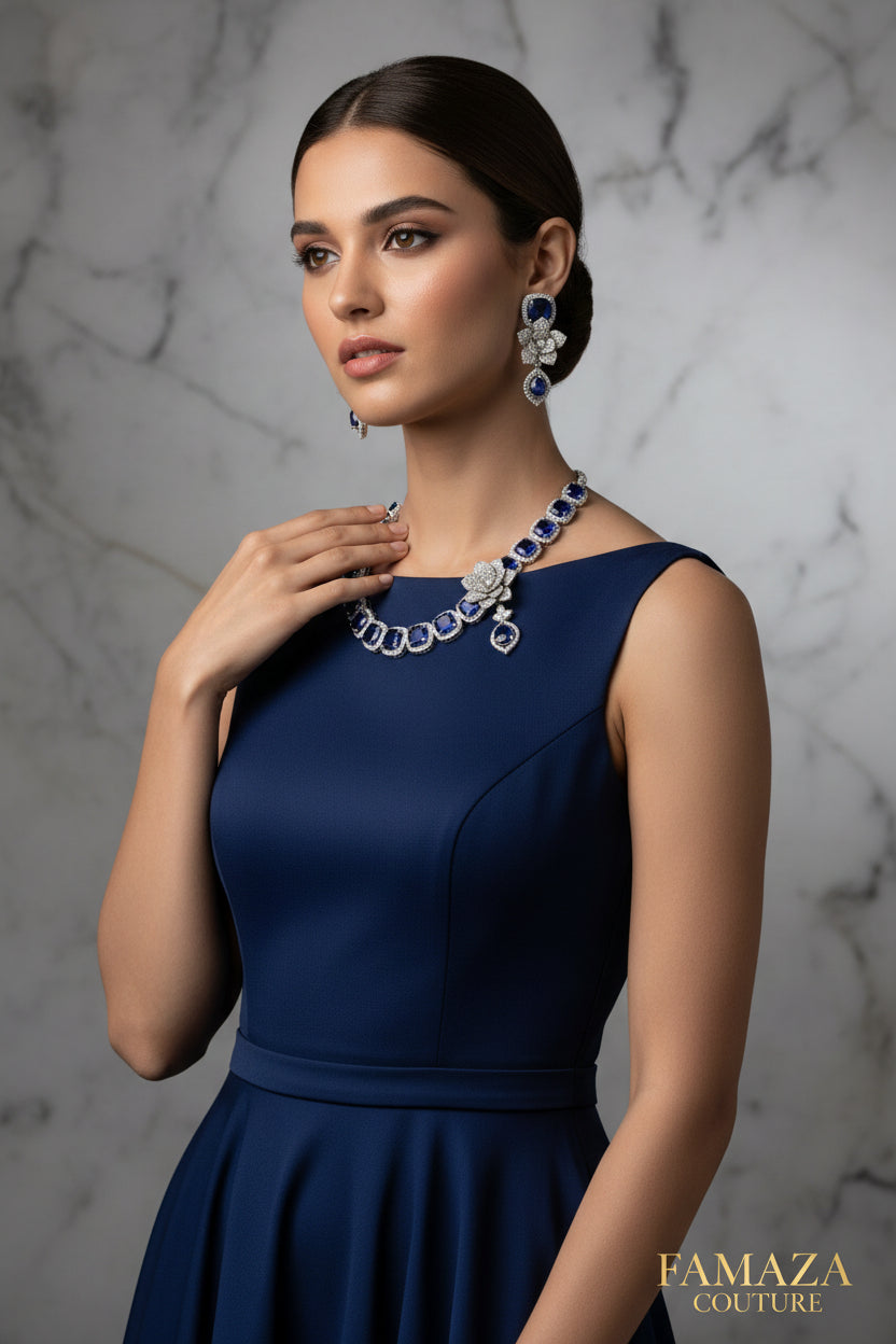 A set of American diamond jewellery consisting of a necklace and earrings with 3D floral elements, featuring blue and white stones.