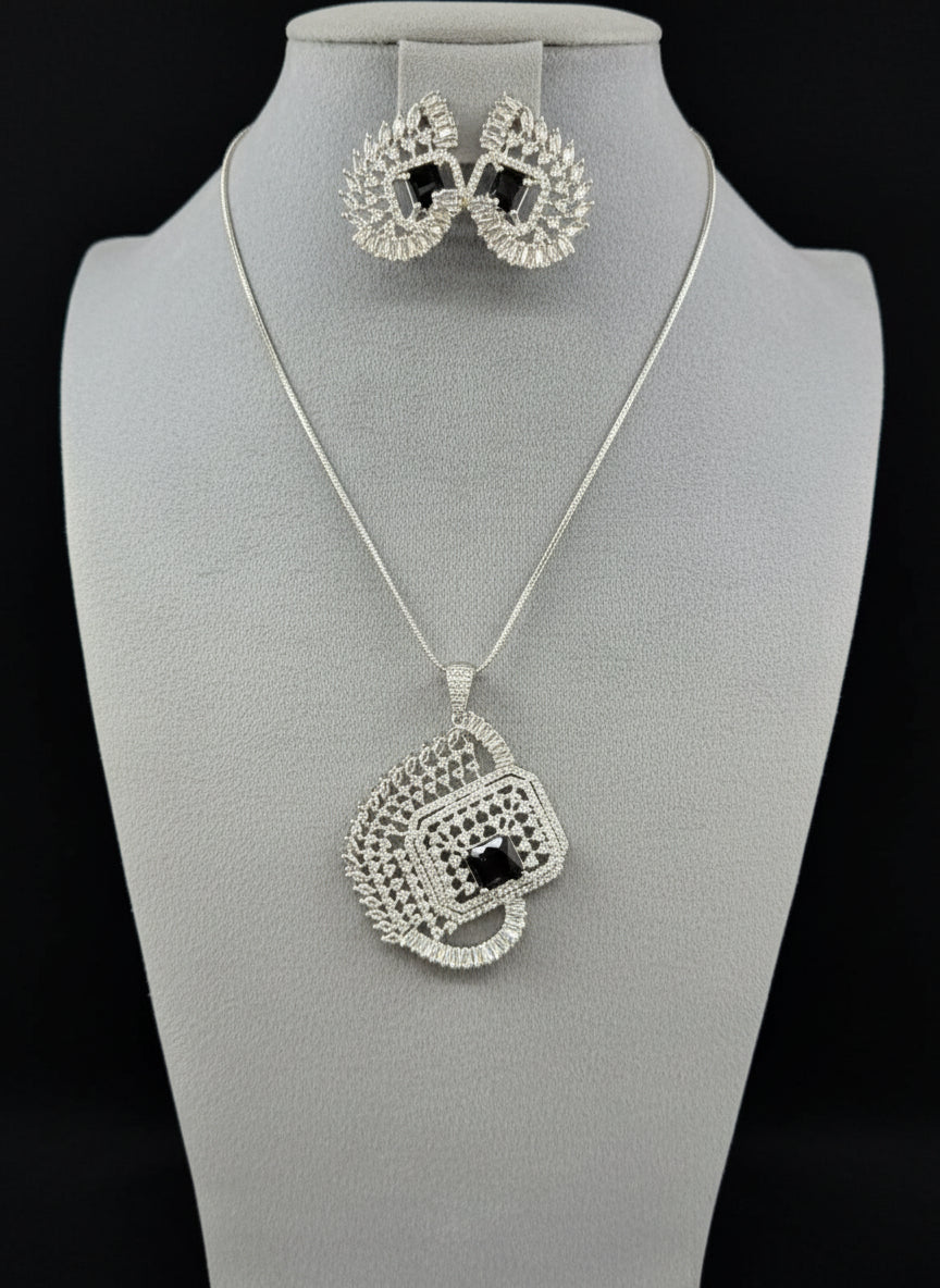 A set of artificial AD pendants with Black centre stone in the pendant and in earrings, featuring a geometric design with intricate detailing, displayed on a mannequin. Party wear set.