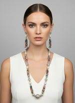 A set of jewellery featuring a long necklace with multi-coloured glass beads and metallic accents, paired with matching earrings, displayed on a mannequin bust.