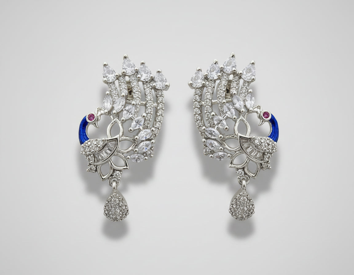 A set of peacock-shaped earrings. The earrings are detailed with blue enamel and has sparkling white AD crystal embellishments.