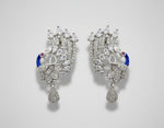 A set of peacock-shaped earrings. The earrings are detailed with blue enamel and has sparkling white AD crystal embellishments.