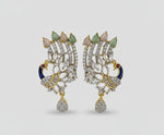 A set of peacock-shaped earrings. The earrings are detailed with blue enamel and has sparkling white and pink AD crystal embellishments. Party wear Earrings. 