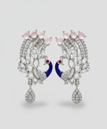A set of peacock-shaped earrings. The earrings are detailed with blueenamel and has sparkling white and pink ad crystal embellishments.