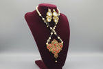 A traditional bridal necklace set displayed on a mannequin, featuring black and gold colours with intricate detailing and pearl beads. Party wear set. 