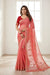 A water melon pink base colour Georgette Saree with chikankari Keel Jaal Embroidery and Resham Work, with a red blouse piece and traditional Indian jewellery.