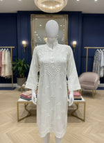 A whiteMuslin fabricwith collar Chikankari short length kurti and three buttons on the front, featuring intricate ghasspati hand embroidery with floral motifs by famaza couture 