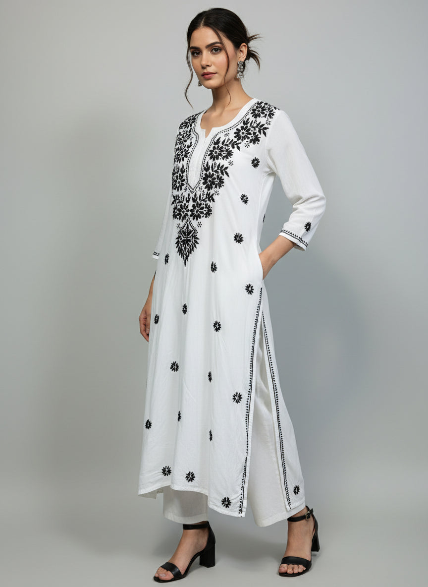 A white long kurti with black coloured embroidery 