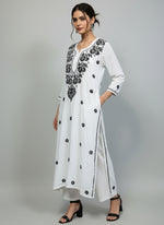 A white long kurti with black coloured embroidery 