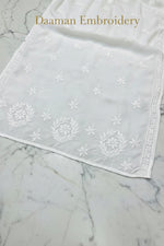 A white modal fabric dense Ghasspati embroidered the lower front border of the Kurti. 