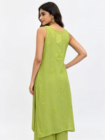 A woman modelling the rear view of this sleeveless lime green kurta with matching green pants, shown from a side-back angle against a plain white studio background.