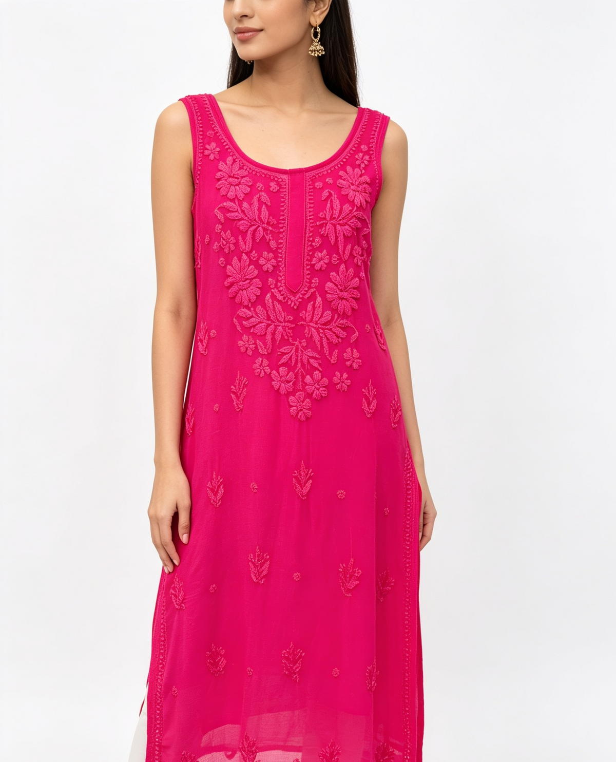 A woman wearing a sleeveless bright pink kurta with floral embroidery and a scoop neckline, shown against a plain white studio background.