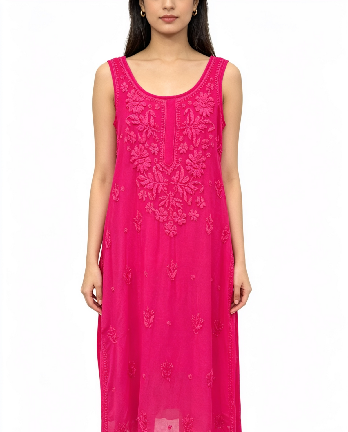 A woman wearing a sleeveless bright pink midi dress with tonal floral embroidery and lace detailing, shown against a plain white background.