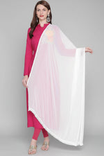 A woman wearing a white chiffon dupatta with lace on both sides, draped over the shoulders.